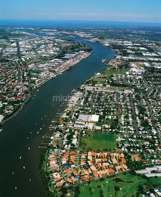 Aerial view of city subdivision and water front with bridge in background. - Mining Photo Stock Library