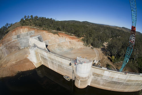Construction of a dam. Aerial shot from crane bucket. - Mining Photo Stock Library