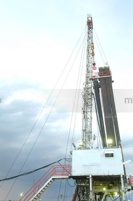 Oil and gas drill rig in afternoon thunderstorm. - Mining Photo Stock Library