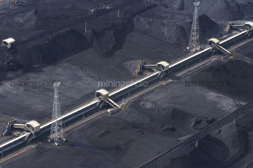 Aerial photo of stockpiled coal at shipping terminal. - Mining Photo Stock Library