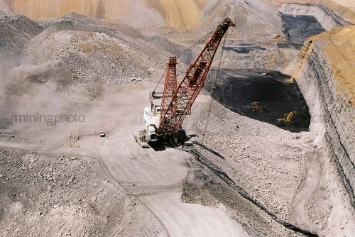Aerial photo of dragline working in open cut coal mine.  coal seams and high walls clearly visible.  digger and truck rotation shifting coal in background. - Mining Photo Stock Library