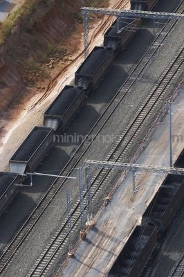 Aerial photo of heavy rail carriages cars carrying coal. - Mining Photo Stock Library