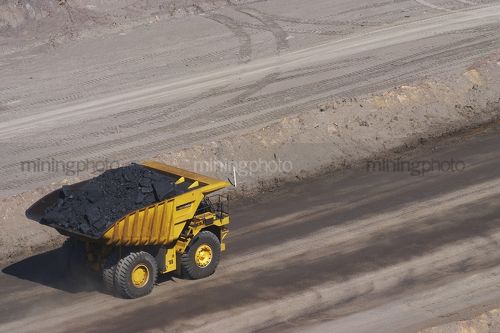 Haul truck loaded with coal in open cut coal mine.  aerial photo. - Mining Photo Stock Library