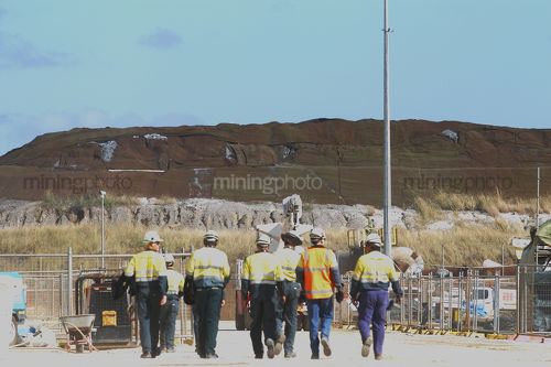Group of mine workers in full PPE walking in shows teamwork.   - Mining Photo Stock Library