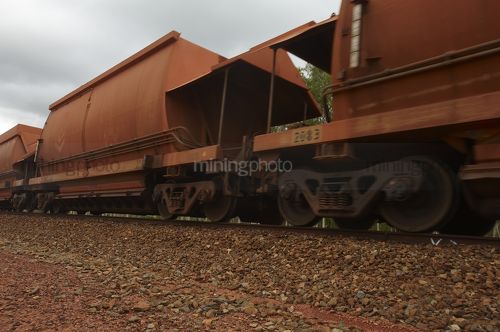 Close up photo of rail train  carriages moving at mine site. - Mining Photo Stock Library