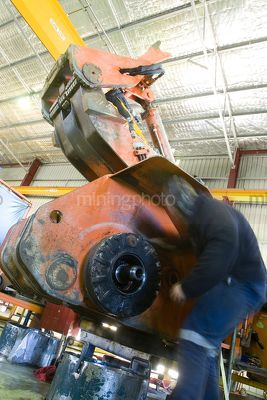 Industry shot of welder worker in full PPE moving around machinery in workshop. - Mining Photo Stock Library