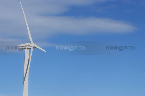 Close up photo of large wind generator.  blue sky behind. - Mining Photo Stock Library
