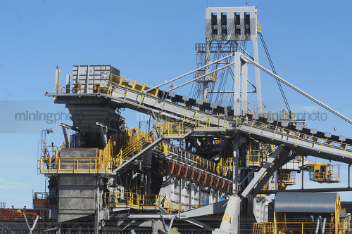 Close up photo of coal shiploader with blue sky behind. - Mining Photo Stock Library