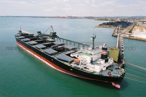 Ship being loaded with coal at terminal - Mining Photo Stock Library