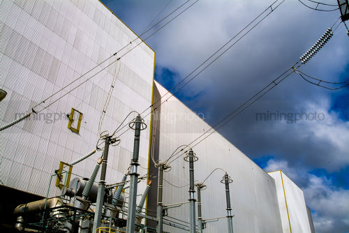 Wall and electricity cables at power station - Mining Photo Stock Library