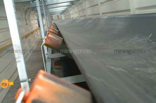 Empty covered new conveyor system shot from inside prior to production - Mining Photo Stock Library