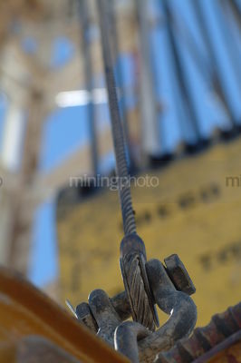 Cable and chain attached to the derrick on an oil and gas drill rig - Mining Photo Stock Library