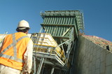 Mining Photo Stock Library - worker in ppe looking up at coal hopper shot from behind ( Weight: 1  New Image: NO)