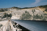 Mining Photo Stock Library - foreman walking back down stockpile conveyor with open cut mine and haul truck in background ( Weight: 1  New Image: NO)