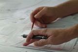 Mining Photo Stock Library - closeup of hands with pen and pencil above engineering plans. good generic shot ( Weight: 2  New Image: NO)