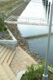 Mining Photo Stock Library - steps leading down to water in canal property subdivision.  jettys and pedestrian bridges to pontoons in background. ( Weight: 3  New Image: NO)