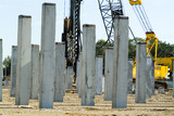 Mining Photo Stock Library - piledriver hammers pre cast concrete piers into the ground as foundation ( Weight: 3  New Image: NO)
