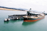 Mining Photo Stock Library - ship loaders loading coal by conveyor into hold of ship. aerial image shot from sea looking to land. ( Weight: 1  New Image: NO)
