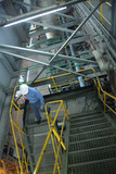Mining Photo Stock Library - worker in full PPE walking down stairs inside power station or factory ( Weight: 3  New Image: NO)