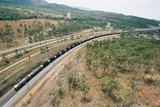 Mining Photo Stock Library - long coal train winding its way over a bridge and through rural countryside with car highway adjacent. aerial shot ( Weight: 1  New Image: NO)