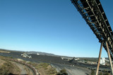 Mining Photo Stock Library - coal conveyor loader above with heavy rail train carriage below and coal stockpiles in background. ( Weight: 2  New Image: NO)