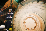 Mining Photo Stock Library - underground mine worker standing next to wheel of machinery ( Weight: 2  New Image: NO)