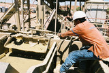 Mining Photo Stock Library - oil and gas rig worker tightening a valve on a rig.  shot from the side. ( Weight: 1  New Image: NO)