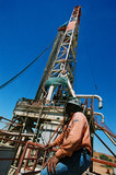 Mining Photo Stock Library - drill rig worker  with fly net  over his head onsite with derrick in background. ( Weight: 1  New Image: NO)