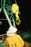 Mining Photo Stock Library - oil and gas rig worker next to derrick hook. shot from behind ( Weight: 1  New Image: NO)