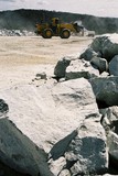 Mining Photo Stock Library - large hard metal overburden rocks in foreground with working loader in background ( Weight: 3  New Image: NO)
