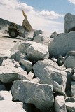Mining Photo Stock Library - haul truck tipping its load onto stockpile in background with hard metal rocks in foreground. ( Weight: 3  New Image: NO)