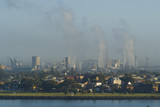 Mining Photo Stock Library - pollution and heavy industry in background with city and residential in front and river in foreground. carbon emission offset image. ( Weight: 1  New Image: NO)