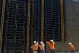 Mining Photo Stock Library - construction workers on infrastructure site lift concrete form work into place with crane. ( Weight: 4  New Image: NO)