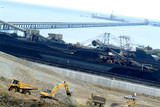 Mining Photo Stock Library - coal terminal conveyor running out to ship being loaded at the wharf.  stockpiled coal and reclaimers working in middle ground. Earthworks and heavy machinery in foreground. ( Weight: 2  New Image: NO)