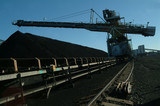 Mining Photo Stock Library - moving conveyor with a coal loader stockpiling in the background. shot late in the day and could be a  silhouette. ( Weight: 5  New Image: NO)