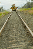 Mining Photo Stock Library - looking along rail track at ground level to track maintenance in distance.  foreground track out of focus. ( Weight: 4  New Image: NO)