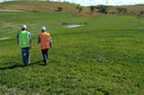 Mining Photo Stock Library - 2 mine workers inspecting green revegetation on open cut coal mine site. ( Weight: 3  New Image: NO)