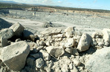 Mining Photo Stock Library - looking over pile of rocks into open cut coal mine with haul truck and haul road behind.  blasting pattern in background. ( Weight: 3  New Image: NO)