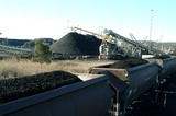 Mining Photo Stock Library - heavy rail carriages loaded with coal in foreground with stacker stockpiling coal in background. ( Weight: 2  New Image: NO)