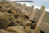 Mining Photo Stock Library - large concrete blocks as ocean retaining wall to stop beach erosion.  rock wall jetty's in background. ( Weight: 2  New Image: NO)