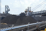 Mining Photo Stock Library - coal reclaimer and ship loader working on coal stockpiles at terminal. moving coal conveyor in foreground.  water sprinklers for dust suppresion working as well.  great production image. ( Weight: 1  New Image: NO)