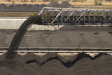Mining Photo Stock Library - close up of coal falling off a conveyor and being stockpiled.  lots of stockpiles in background.  great generic coal production image. ( Weight: 1  New Image: NO)