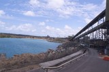 Mining Photo Stock Library - conveyor at coal terminal passing next to ocean and site fence. ( Weight: 4  New Image: NO)