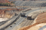 Mining Photo Stock Library - loaded haul truck passes empty truck on circuit at open cut gold mine. light vehicles follow. ( Weight: 1  New Image: NO)