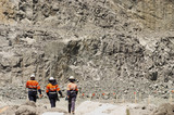 Mining Photo Stock Library - three 3 mine workers walking in full PPE along pit floor of open cut gold mine. ( Weight: 1  New Image: NO)