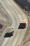 Mining Photo Stock Library - aerial, vertical shot of loaded haul trucks passing on gold haul road. ( Weight: 1  New Image: NO)