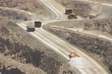Mining Photo Stock Library - water cart spraying water oin haul road with loaded and empty haul trucks n background. ( Weight: 1  New Image: NO)