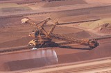 Mining Photo Stock Library - iron ore reclaimer working at ship terminal. water sprayer for dust suppression with light vehicle adjacent for scale. ( Weight: 1  New Image: NO)