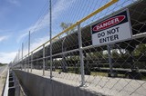 Mining Photo Stock Library - covered coal conveyor behind wire fence with do not enter sign posted. ( Weight: 1  New Image: NO)