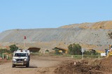 Mining Photo Stock Library - light vehicle on access road of open cut mine with overburden stockpiles in background. ( Weight: 1  New Image: NO)